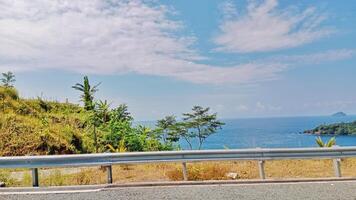Beautiful Hillside Road View with Bright Blue Sky and Open Skyline photo