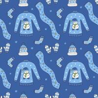 Seamless pattern with winter clothes on blue background vector
