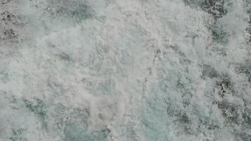 Close-Up of Foaming Water in Motion, Detailed texture of white foaming water in motion, capturing the turbulent energy and dynamic movement of natural waves. video
