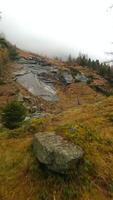 FPV drone flies quickly through the fog close to the stone surface. Austria video