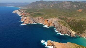 Aerial view seashore cliffs wave crashing on rocks. Sardinia, Italy. video
