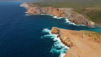 Aerial view seashore cliffs wave crashing on rocks. Sardinia, Italy. video