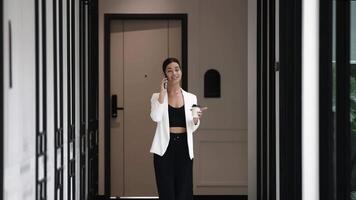 Businesswoman talking on phone during coffee break in modern office with panoramic windows. networking and discussion, share ideas at conference. Digital marketing and brainstorming. video