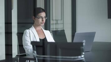 Businesswoman using computer to analyze cryptocurrency trading. Broker investor discussing dynamic stock market with business partners comparing real-time, exchange rate, investment in risk data video