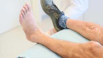 nurse in a clinic prepares for a procedure on a patient's broken leg after removing a plaster cast, following instructions, adhering to the concept of professional care, video
