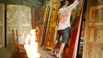 Carpenter Applying Polish Next To Fire video