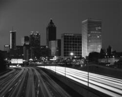 Dusk Cityscape with Skyscrapers and Street Lights Illuminating the Towering Architecture photo