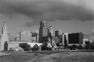 Urban Skyline with Skyscrapers and Greenery Against a Cloudy Sky photo