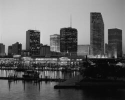 Modern Cityscape at Dusk Skyscrapers Reflected in Tranquil Waters photo