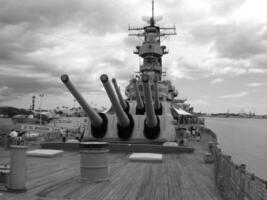 Navy Battle Ship With Guns and Other Weapons Background photo