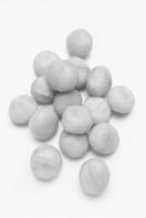 Raw Macadamia Nuts on Wooden Background photo