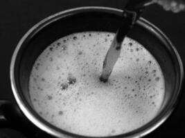 Cup of Liquid Ingredient in Kitchen Utensil Setting photo