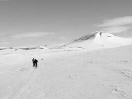 Snow-Covered Mountain Slope with Ski Equipment and Clouds in the Sky photo