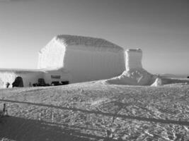 Snowy Slope with Ice Cap and Vehicle Under Sky photo