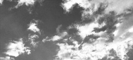 Deep blue sky with white clouds background. Pencil sketch drawing photo