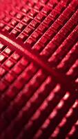 A mesmerizing close-up of a textured red surface, revealing intricate details and a captivating pattern. The interplay of light and shadow creates a stunning visual effect. video