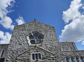 Cumulus Clouds Over a Blue Sky and Building Window photo