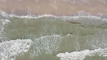 Aerial view of waves on a sandy tropical beach. video