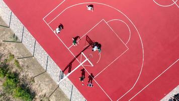 Aerial view of young athletes playing streetball on an open summer playground. video