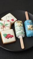 Natural popsicle ice cream on a stick covered with chocolate in the style and colors of Christmas and New Year on a dark concrete background video
