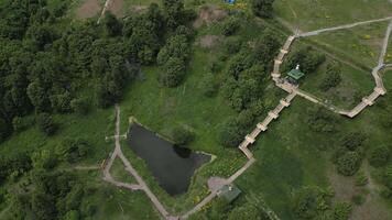 A beautiful Aerial View of a Scenic Park showcasing the pathways and a serene pond. Clip video