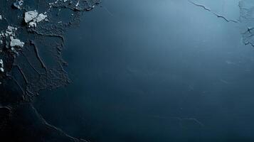 Dark textured wall with cracks and peeling paint in a dimly lit setting showcasing an atmospheric background photo
