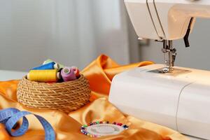 Sewing machine in use on a wooden table, stitching a light fabric in a well-lit indoor workspace photo