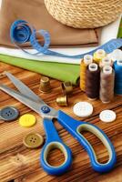 Crafting tools and materials arranged on a wooden table for sewing projects photo