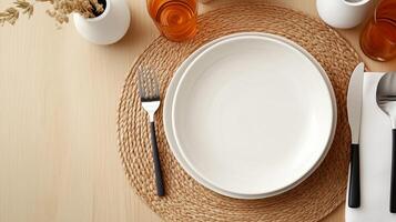 Set table ready for dining with plain white plate, utensils, and decorative elements in warm tones photo