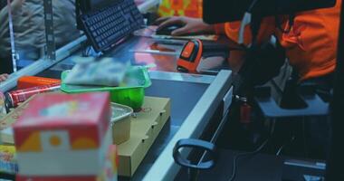 A person in an orange shirt is working on a computer video