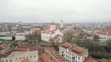 Scenic autumn view rising aerial Lithuania Vilnius panorama of modern business financial district architecture buildings and Old Town in Vilnius, Lithuania. Hazy cold winter day in capital Vilnius video