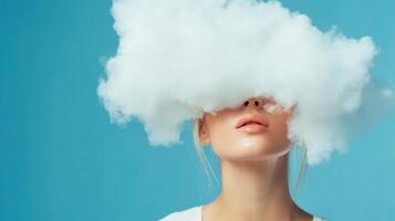 Model with cloud covering her face poses against a bright blue background in a creative and artistic setting photo
