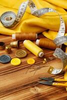 Crafting tools and materials arranged on a wooden table for sewing projects photo