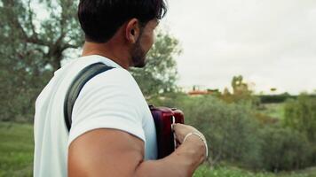 Enthusiastic Accordionist Performing in Rustic Landscape video
