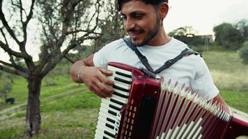 Smiling Accordionist In The Green Grass video