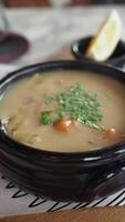 A Mouthwatering Bowl of Rich and Creamy Soup Served Lovingly in a Rustic Black Pot video