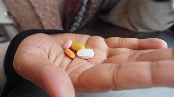 A Variety of Assorted Pills Held in Hand for Optimal Health and Wellness video