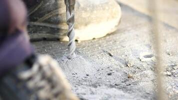 A CloseUp of a Power Drill Actively Being Used on a Concrete Surface video