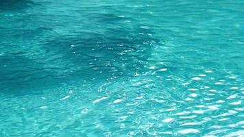 Abstract blue color water, pure natural swirl pattern texture, background photography. Top view of a blue calm and clear water surface, water texture with ripples and shadow. Summer banner concept video
