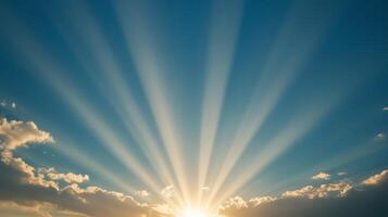 Bright rays of sunlight break through clouds in a tranquil sky at dawn, signaling the start of a new day photo