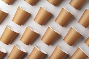 A collection of disposable paper cups arranged in a repeating pattern on a light background photo