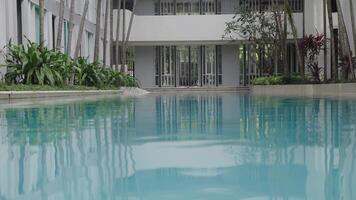 Luxury Minimalist Villa Exterior With Pool View. Low-angle shot of a reflection pool with water flowing over the sides in a villa. video