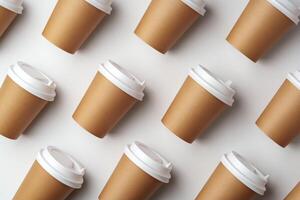 A collection of disposable paper cups arranged in a repeating pattern on a light background photo