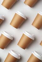 A collection of disposable paper cups arranged in a repeating pattern on a light background photo