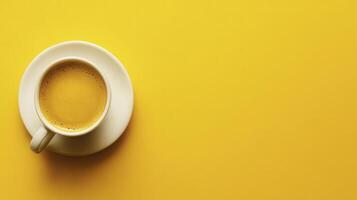 A cup of coffee on a vibrant yellow background, highlighting a simple morning beverage for a refreshing start to the day photo