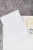 blank magazine mockup on coffee table with green matcha tea near window photo