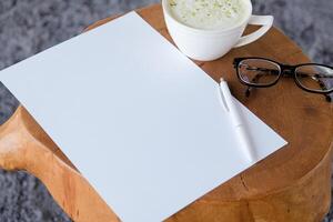 blank paper sheet mockup on coffee table with green matcha tea photo