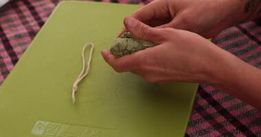 Hands make unique Christmas crafts holiday-themed project with recycled egg cartons. Step-by-step instructions for making handmade Christmas ornament from recycled paper clay and rope hanging video