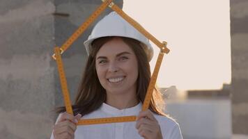 Female architect holding folding ruler on construction site at sunset video