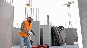 Funny construction worker dancing. Positive dance of builders in helmet. Construction engineer in builder uniform dancing on his work place video